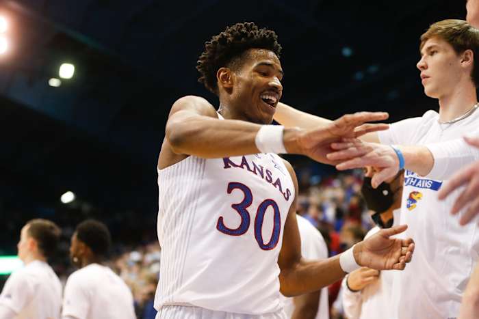 Kansas senior guard Ochai Agbaji (30) is received back on the bench after a stellar performance in the second half of Saturday's game against Baylor inside Allen Fieldhouse.